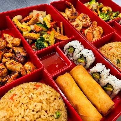 Red hibachi bento with chicken, shrimp, rice, sushi and spring rolls