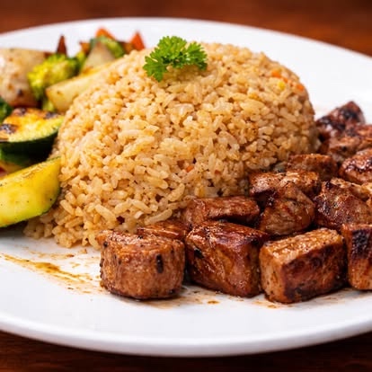 Hibachi steak with fried rice and grilled vegetables