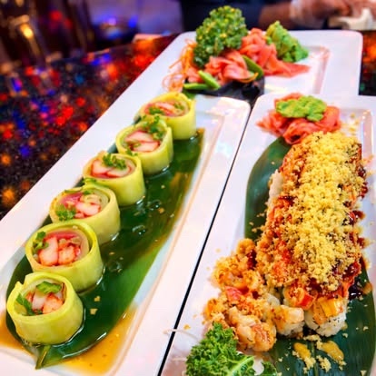Two colorful specialty sushi plates on the restaurant counter