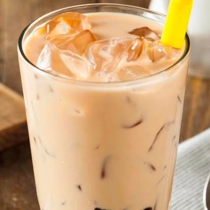 Iced Thai milk tea with a yellow straw